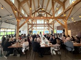 Community Futures Peterborough's executive director Devon Girard speaks to the audience at the economic development organization's annual general meeting on June 26, 2025 at Farmhill Weddings in Keene. The economic development organization is celebrating 40 years of providing financing and advice and support to small businesses in the city and county of Peterborough. (Photo courtesy of Community Futures Peterborough)