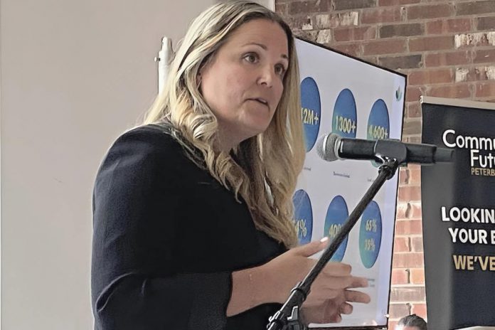 Devon Girard, executive director of Community Futures Peterborough, speaks to the audience at the economic development organization's annual general meeting on June 26, 2025 at Farmhill Weddings in Keene. (Photo: Paul Rellinger / kawarthaNOW)