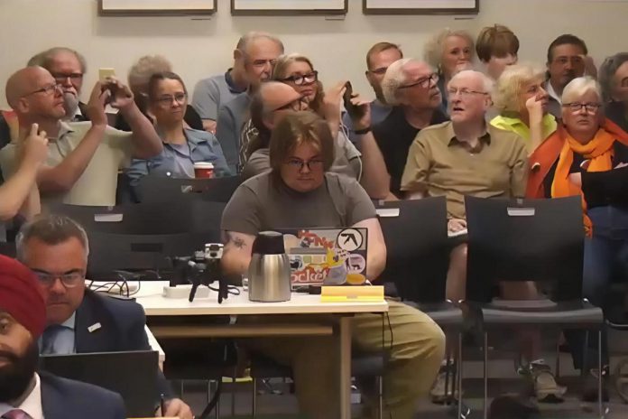 Members of the public in the gallery at Peterborough city council's general committee meeting on June 2, 2025 react to a 7-3 vote by council in favour of councillor Gary Baldwin's motion against penalizing Mayor Leal for contravening the code of conduct in response to a report by the City of Peterborough's integrity commissioner Guy Giorno that concluded the mayor had intimidated councillor Alex Bierk and bullied councillor Joy Lachica. (kawarthaNOW screenshot of City of Peterborough video)