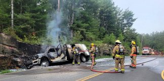 Fire crews extinguished a commercial vehicle carrying oxygen bottles after it left County Road 503 near Kinmount on June 17, 2025 and struck a rock cut, later catching on fire. (Photo: Peterborough County OPP)