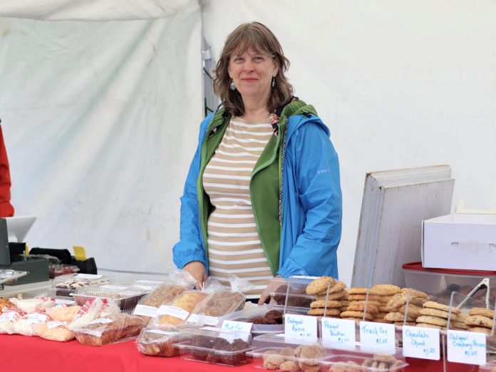 Jennie MacKenzie is the founder of Jen's Home Baking, a Lakefield-based small business that has been a vendor at the Lakefield Farmers' Market in the Township of Selwyn since the market was founded in 2010. Now in its 16th season, the market runs every Thursday morning between 9 a.m. and 1 p.m. in the parking lot behind the Lakefield-Smith Community Centre, and supports local farmers, small businesses, and the region's tourism sector. (Photo courtesy of Lakefield Farmers' Market) Jennie MacKenzie is the founder of Jen's Home Baking, a Lakefield-based small business that has been a vendor at the Lakefield Farmers' Market in the Township of Selwyn since the market was founded in 2010. Now in its 16th season, the market runs every Thursday morning between 9 a.m. and 1 p.m. in the parking lot behind the Lakefield-Smith Community Centre, and supports local farmers, small businesses, and the region's tourism sector. (Photo courtesy of Lakefield Farmers' Market)