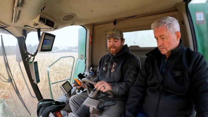 Chris Brackenridge of Squirrel Creek Farm teaches Millbrook resident David McNab about farming for a video about the farmers' way of life and the challenges they face. What began with a kind gesture from the Brackenridge family to visiting farmers from the Galapagos Islands led to McNab filming four seasons' worth of footage on the farm. The footage was recently sold to the Ontario Federation of Agriculture for enough money to support six years of school for the 12-year-old son of a female farmer in Kenya that McNab has been sponsoring. (kawarthaNOW screenshot of David McNab video)
