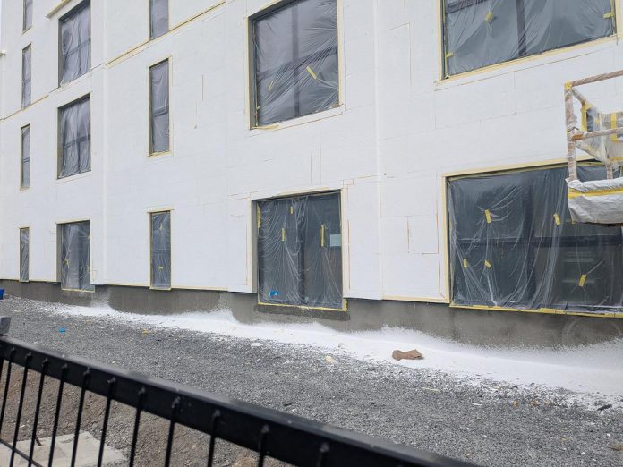 While insulated concrete forms (ICF) have historically been common for below-grade applications, above-grade ICF walls are increasingly being used for the entire building envelope. Ashburnham Realty is the developer behind the six-storey building off the Rotary trail south of Hunter Street East and north of Robinson Street in Peterborough's East City, and owner Paul Bennett has been responsive to the complaints of resident Megan Boyles about ICF particles getting into the environment, although she remains unsatisfied with the remediation efforts. (Photo: Megan Boyles)