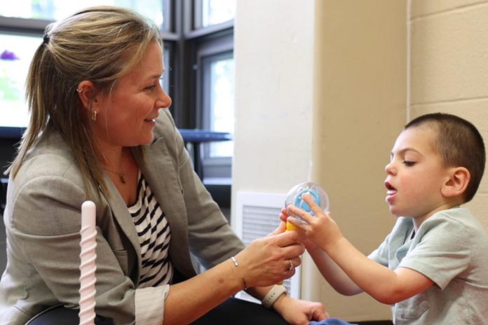 Five Counties Children's Centre occupational therapist Jess shares a smile with Five Counties client Jude during a recent treatment session. In 2024-25, Five Counties served the highest number of annual clients so far in its 50-year history, with a record 6,208 children and youth with disabilities receiving services from the regional treatment centre. (Photo: Five Counties) Five Counties Children's Centre occupational therapist Jess shares a smile with Five Counties client Jude during a recent treatment session. In 2024-25, Five Counties served the highest number of annual clients so far in its 50-year history, with a record 6,208 children and youth with disabilities receiving services from the regional treatment centre. (Photo: Five Counties)