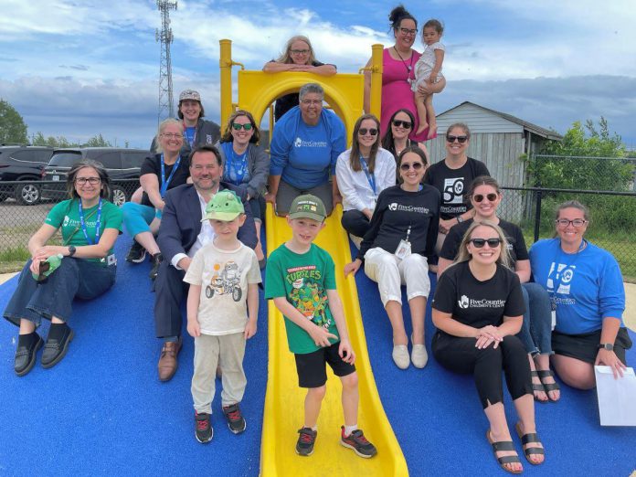 It's all smiles as local families and Five Counties staff embrace the transition of a field of dreams behind the Five Counties Children's Centre site in Cobourg into a safe, fully accessible backyard space. The $376,000 project was a true example of how partner agencies, the Ontario government, and the Northumberland community came together to turn a "field of dreams" into a reality for children with disabilities or exceptionalities, their families, and service providers. (Photo courtesy of Five Counties Children's Centre)
