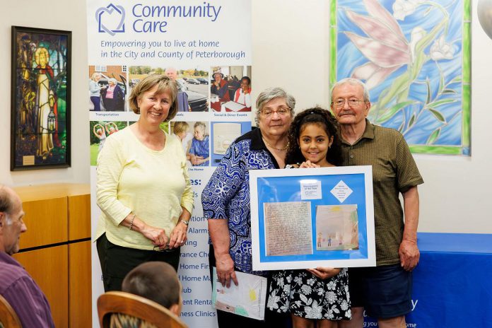 Prince of Wales Public School Grade 3 student Zinnia Ricciuti won a Grandparent of the Year award for her essay and hand-drawn picture honouring her nonna and nonno (the Italian words for grandmother and grandfather), who are pictured with Community Care Peterborough board president Dr. Janet Kelly at Royal Gardens Retirement Residence in Peterborough on June 5, 2025. (Photo: Kayla Le Franc)