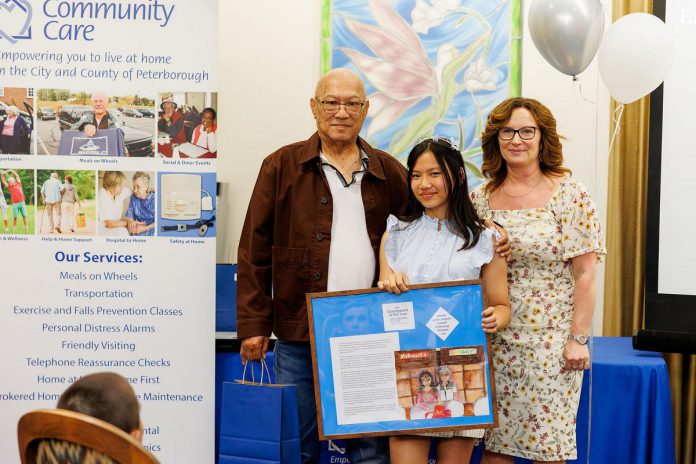 St. Teresa Catholic Elementary School Grade 5 student Kaliyah Espiritu won a Grandparent of the Year award for her essay and hand-drawn picture honouring her grandpa Jun Espiritu, pictured with Community Care Peterborough CEO Danielle Belair at Royal Gardens Retirement Residence in Peterborough on June 5, 2025. (Photo: Kayla Le Franc)