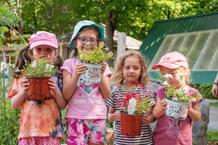 Day campers planting in Abby's Garden at Camp Kawartha. Practicing stewardship at a young age informs tomorrow's leaders about sustainable practices. (Photo courtesy of Camp Kawartha)