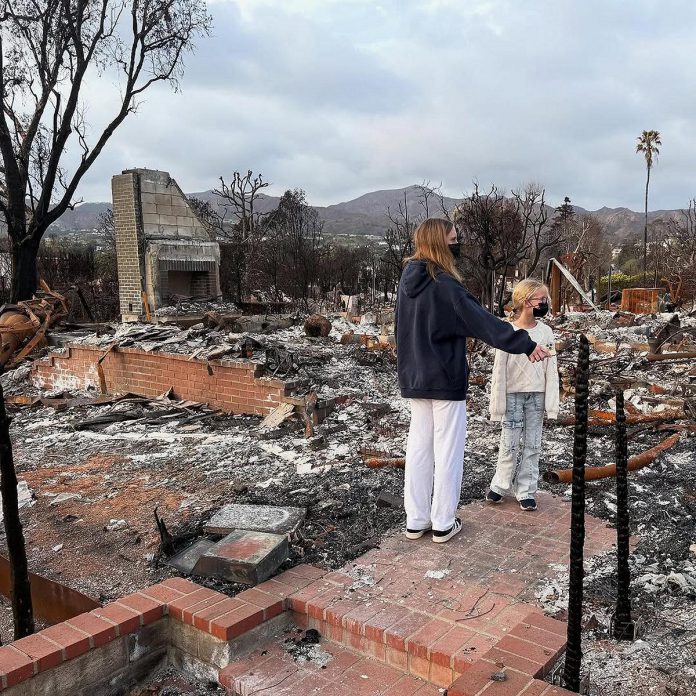 Greg Wells' daughters survey the destruction of the family home two months after the devastating wildfires in January 2025 ravaged much of Los Angeles. (Photo: Greg Wells / Instagram)