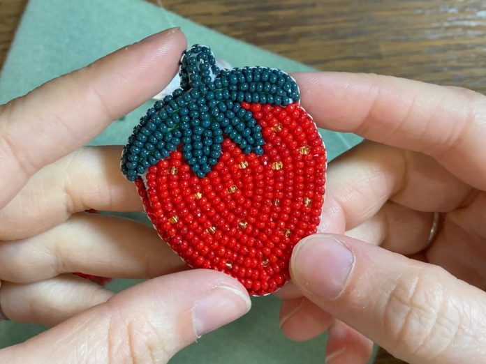 During the New Canadians Centre's "Lessons from the Land" event on July 1, 2025 at the Jiimaan Kinomaagewin / Canadian Canoe Museum, Jaida Ponce from Ardoch Algonquin First Nation will lead strawberry pin beading circle. (Photo: New Canadians Centre)