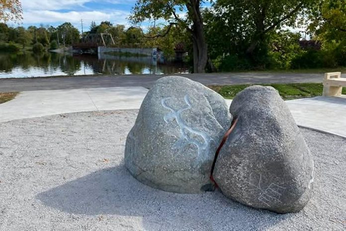 Located adjacent to the interpretive panels and installed in 202, "Gathering" by Anishinaabe sculptor Michael Belmore is a public artwork funded by the City of Peterborough that features a grouping of glacial erratic boulders embellished with the Treaty 20 Clan Dodems. (Photo: City of Peterborough)