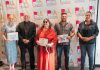 The recipients of the Peterborough Arts Awards on June 12, 2025 at the Canadian Canoe Museum: Rebecca Birrell for her father Syd Birrell (Outstanding Senior Artist), David Goyette (Arts Champion), Lynda Todd (Outstanding Emerging Artist), Chad Hogan (Arts Catalyst), and Olivia Whetung (Outstanding Mid-Career Artist). Not pictured is Sarah Decarlo (Outstanding Achievement by an Indigenous Artist). Each award winner received $2,000 and a pin created by local artists Christy Haldane and Valerie Davidson. (Photo courtesy of Electric City Culture Council)