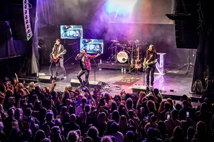 Retro rock tribute band Neon Nostalgic (Shawn Brady, Kevin Strom, Grant Strom, and John Johnstone) performs a free-admission concert in Del Crary Park on July 1, 2025 for the Canada Day edition of Peterborough Musicfest. The band performs hits from the 1980s and 1990s in synch with the artists' original music videos for the songs they perform. (Photo: Serrano Photography Studios) Retro rock tribute band Neon Nostalgic (Shawn Brady, Kevin Strom, Grant Strom, and John Johnstone) performs a free-admission concert in Del Crary Park on July 1, 2025 for the Canada Day edition of Peterborough Musicfest. The band performs hits from the 1980s and 1990s in synch with the artists' original music videos for the songs they perform. (Photo: Serrano Photography Studios)