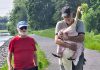 Peterborough residents Steve Paul (right) and Peter Hewitt captured a potentially injured trumpeter swan along the Trent Canal trail just south of the Parkhill swing bridge on June 4, 2025, with Paul then driving it to the Shades of Hope Wildlife Refuge. Two days earlier, Hewitt and Karen Hjort-Jensen had sat with the swan for more than two hours after noticing the swan was behaving strangely and reached out to various organizations for help, including Trumpeter Swan Conservation Ontario which connected them with volunteer Paul. (Photo: Karen Hjort-Jensen)