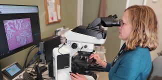 Dr. Katie O'Reilly, pathologist and medical director of laboratory medicine at Peterborough Regional Health Centre (PRHC), examines a tissue sample. The PRHC Foundation has made it a priority to invest in the future of cancer care by bringing digital pathology to the regional hospital, with the help of donors. An area of focus for the Foundation's $60 million Campaign for PRHC, the state-of-the-art technology will produce efficient and more accurate diagnoses, reduce turnaround time, and empower world-class healthcare close to home. (Photo courtesy of PRHC Foundation)