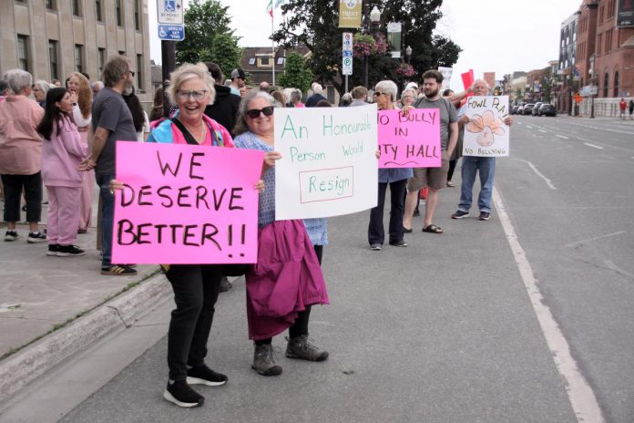 Some of the signs held by a crowd of around 75 people attending the "Rally for Integrity" outside of Peterborough City Hall on June 9, 2025. During a subsequent city council meeting, seven of 10 public delegations urged city councillors to hold Mayor Jeff Leal to account for breaching council's code of conduct by intimidating councillor Alex Bierk and then bullying councillor Joy Lachica as reported by the city's integrity commissioner. (Photo: Jeannine Taylor / kawarthaNOW)