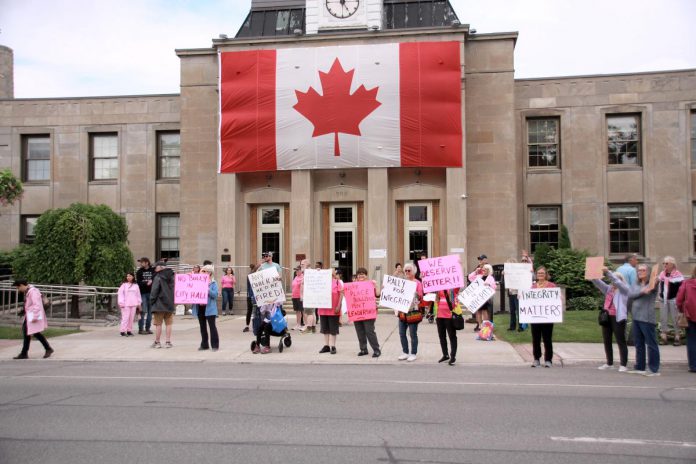 Despite the hopes of around 75 people attending the "Rally for Integrity" outside of Peterborough City Hall on June 9, 2025, who urged city councillors to hold Mayor Jeff Leal to account for breaching council's code of conduct by intimidating councillor Alex Bierk and then bullying councillor Joy Lachica as reported by the city's integrity commissioner, councillors later voted 6-4 to ratify an earlier decision not to penalize the mayor. (Photo: Jeannine Taylor / kawarthaNOW)