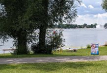 Peterborough Public Health closed the beach at Rogers Cove in Peterborough's East City in July 2023 after a harmful blue-green algae bloom was confirmed. For summer 2025, the health unit will no longer be testing the water quality at the beach, and the City of Peterborough will no longer be providing lifeguard services. (Photo: Bruce Head / kawarthaNOW)