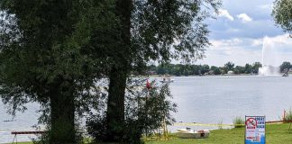 Peterborough Public Health closed the beach at Rogers Cove in Peterborough's East City in July 2023 after a harmful blue-green algae bloom was confirmed. For summer 2025, the health unit will no longer be testing the water quality at the beach, and the City of Peterborough will no longer be providing lifeguard services. (Photo: Bruce Head / kawarthaNOW)