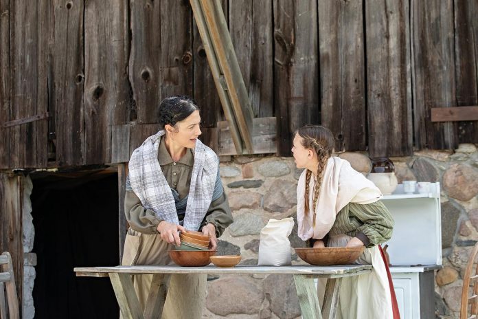 Actors Lindsay Wilson and Indigo Chesser perform a scene from "Wild Irish Geese" at a media event at 4th Line Theatre's Winslow Farm on July 16, 2025. Written by Megan Murphy and directed by Kim Blackwell, the play runs from July 29 to August 30 at the Winslow Farm in Millbrook, coinciding with a number of other events in August commemorating the bicentennial of the Robinson emigration. (Photo: Jordan Lyall Photography for kawarthaNOW)
