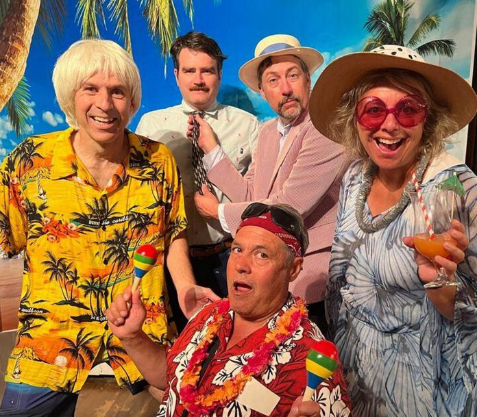 The cast of Globus Theatre's 2023 summer murder mystery dinner theatre event "The Great Palm Tree Beach Tiki Bar Tragedy," including Kerry Griffin (left). Griffin has been participating in the murder mysteries held at the Bobcaygeon theatre company for the past decade and, as a professional improvisor, loves them for their unpredictable nature. (Photo courtesy of Globus Theatre)