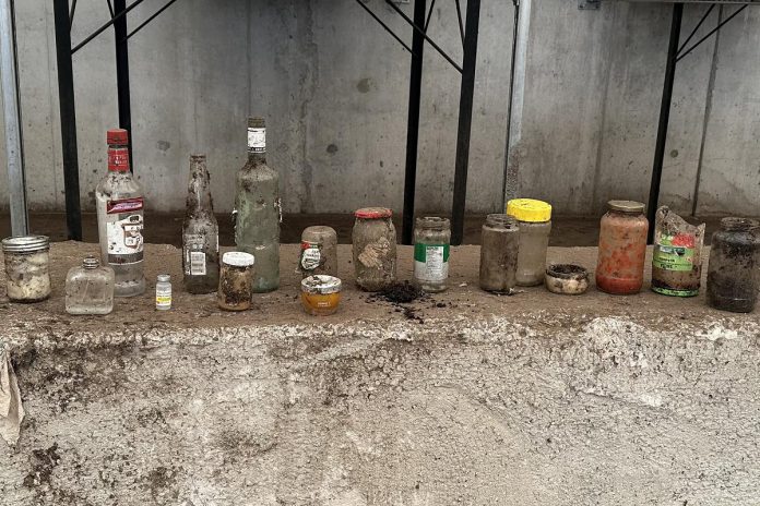 Despite the success of the City of Peterborough's organics program, contamination of organic waste continues to be an issue. Glass and metal are some of the worst contaminants in organics because sharp fragments can reduce the quality of the entire batch of finished compost and can pose a hazard to end users. Pictured are some of the glass bottles and jars pulled from organics at the Peterborough Organics Facility during various stages of processing. (Photo: Barry Campbell / City of Peterborough)
