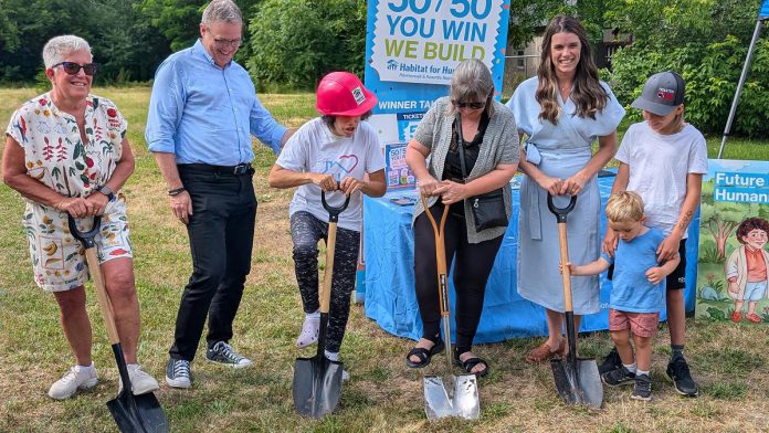 Habitat for Humanity Peterborough & Kawartha Region (Habitat PKR) and Our Daughters' Home broke ground on an accessible duplex, to be built on Sophia Street in Peterborough East City for seven adult women with developmental disabilities, on July 9, 2025. Pictured from left to right are Our Daughters' Home treasurer Debby Donaghy, Peterborough city councillor Matt Crowley, Donaghy's daughter Michelle (one of the seven women who will live in the home), Habitat PKR board chair Hope Lee, and Peterborough MP Emma Harrison with two of her children. (Photo: Bruce Head / kawarthaNOW) Habitat for Humanity Peterborough & Kawartha Region (Habitat PKR) and Our Daughters' Home broke ground on an accessible duplex, to be built on Sophia Street in Peterborough East City for seven adult women with developmental disabilities, on July 9, 2025. Pictured from left to right are Our Daughters' Home treasurer Debby Donaghy, Peterborough city councillor Matt Crowley, Donaghy's daughter Michelle (one of the seven women who will live in the home), Habitat PKR board chair Hope Lee, and Peterborough MP Emma Harrison with two of her children. (Photo: Bruce Head / kawarthaNOW)
