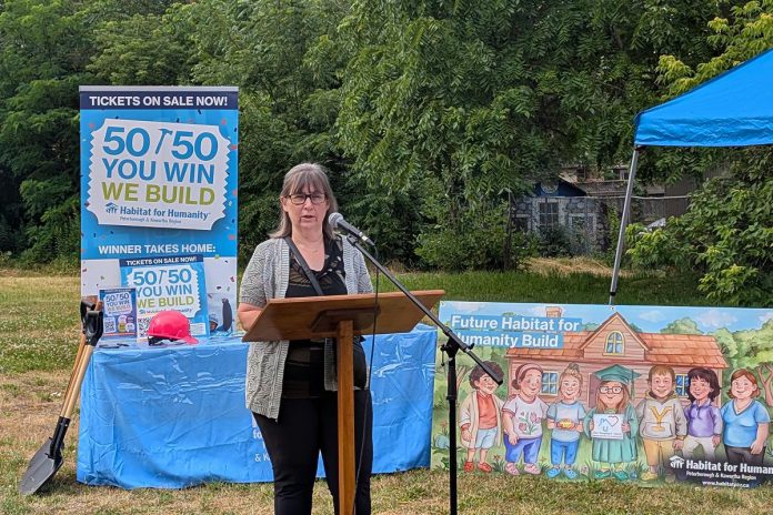 Habitat for Humanity Peterborough & Kawartha Region board chair Hope Lee addresses attendees at a ground-breaking ceremony on July 9, 2025 for an accessible duplex to be built on Sophia Street in Peterborough East City for seven adult women with developmental disabilities. (Photo: Bruce Head / kawarthaNOW)