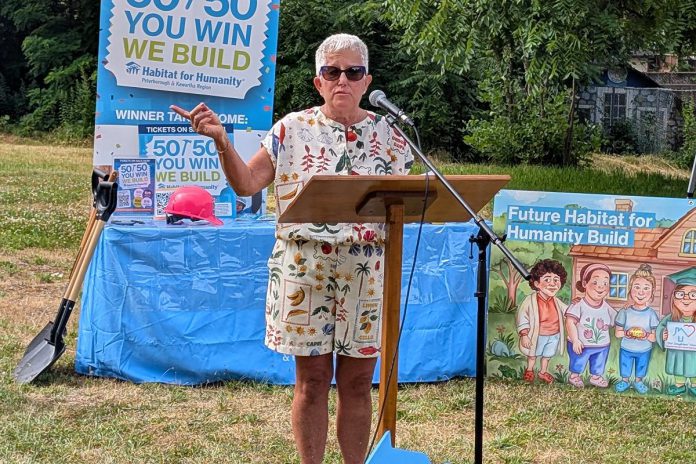 Our Daughters' Home treasurer Debby Donaghy addresses attendees at a ground-breaking ceremony on July 9, 2025 for an accessible duplex to be built on Sophia Street in Peterborough East City for seven adult women with developmental disabilities. (Photo: Bruce Head / kawarthaNOW)