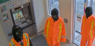 Three male suspects in the atrium of the Kawartha Credit Union branch at 4088 County Rd 121 in Kinmount on June 30, 2025. (Police-supplied photo)