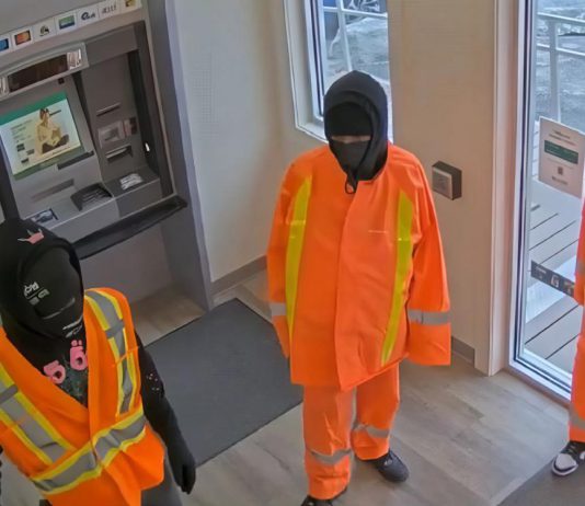 Three male suspects in the atrium of the Kawartha Credit Union branch at 4088 County Rd 121 in Kinmount on June 30, 2025. (Police-supplied photo)