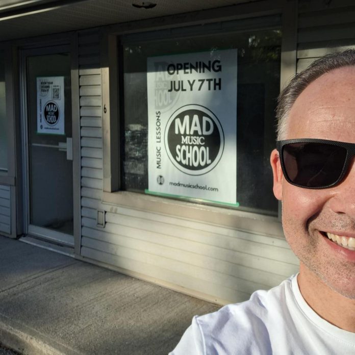 Michael Beauclerc outside his new Mad Music School in Juliann's Plaza at 3347 Lakefield Road. While the school officially opens on July 7, 2025, Beauclerc is hosting a family-friendly soft-opening celebration from 10 a.m. to noon on July 6 featuring live instructor demos, a tour of the studios, treats and refreshments from Stuff'd bakery, and raffle prizes donated by other local businesses. (Photo: Michael Beauclerc)