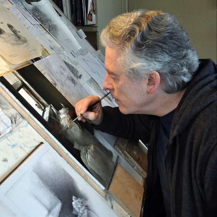 Internationally renowned Buckhorn-based wildlife artist Michael Dumas in his studio in 2017 working on his oil painting "Looking Out" featuring an eastern phoebe in a flour mill. (Photo courtesy of Michael Dumas)