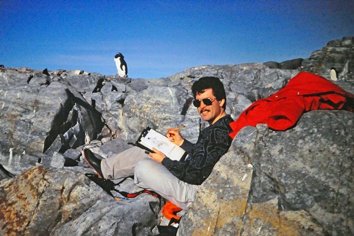 Michael Dumas sketching a penguin on Avian Island in Antarctica in 1990. (Photo courtesy of Michael Dumas)