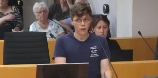 Auden Palmer, director of outreach services at One City Peterborough, addresses Peterborough city council on July 2, 2025 before councillors voted 6-5 against providing continued funding for expanded services at Trinity Centre in 2026 for people experiencing homelessness. (kawarthaNOW screenshot of City of Peterborough video)