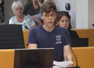 Auden Palmer, director of outreach services at One City Peterborough, addresses Peterborough city council on July 2, 2025 before councillors voted 6-5 against providing continued funding for expanded services at Trinity Centre in 2026 for people experiencing homelessness. (kawarthaNOW screenshot of City of Peterborough video)