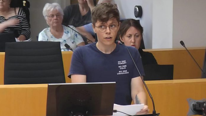 Auden Palmer, director of outreach services at One City Peterborough, addresses Peterborough city council on July 2, 2025 before councillors voted 6-5 against providing continued funding for expanded services at Trinity Centre in 2026 for people experiencing homelessness. (kawarthaNOW screenshot of City of Peterborough video) Auden Palmer, director of outreach services at One City Peterborough, addresses Peterborough city council on July 2, 2025 before councillors voted 6-5 against providing continued funding for expanded services at Trinity Centre in 2026 for people experiencing homelessness. (kawarthaNOW screenshot of City of Peterborough video)