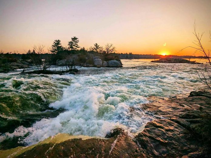 The sun sets over the fast-flowing rapids at Burleigh Falls in the Township of North Kawartha. (Photo: Lovesick Kayaking)