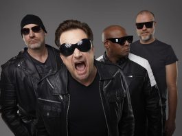 U2 tribute band Acrobat (Martin Chorlton as The Edge, Gabriel Pate as Bono, Mark Baker as Adam Clayton, and Michael Wood as Larry Mullen Jr.) performs a free-admission concert at Peterborough Musicfest in Del Crary Park on August 2, 2025. (Publicity photo)