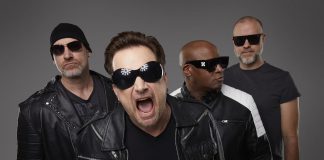 U2 tribute band Acrobat (Martin Chorlton as The Edge, Gabriel Pate as Bono, Mark Baker as Adam Clayton, and Michael Wood as Larry Mullen Jr.) performs a free-admission concert at Peterborough Musicfest in Del Crary Park on August 2, 2025. (Publicity photo)