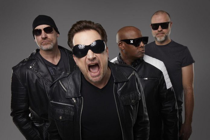 U2 tribute band Acrobat (Martin Chorlton as The Edge, Gabriel Pate as Bono, Mark Baker as Adam Clayton, and Michael Wood as Larry Mullen Jr.) performs a free-admission concert at Peterborough Musicfest in Del Crary Park on August 2, 2025. (Publicity photo) U2 tribute band Acrobat (Martin Chorlton as The Edge, Gabriel Pate as Bono, Mark Baker as Adam Clayton, and Michael Wood as Larry Mullen Jr.) performs a free-admission concert at Peterborough Musicfest in Del Crary Park on August 2, 2025. (Publicity photo)