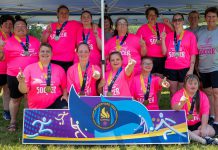 The Peterborough Special Olympic women's soccer team (Candace Bushie, Crystal Cochrane, Jasmine Davis, Haley Fowler, Heather Fowler, Nicole Hewitt, Kristen Lackey, Gillian McHugh, Miriam McHugh, Kacee Quinlan, Jenn Wildman, and Carlea Wilkie-Ellis) with coaches Debbie Quinlan, Shawna Goode, and Linda Wilkie celebrating the first-ever gold medal in the women's soccer division at the Special Olympics provincial games, held in Brantford from July 10 to 13, 2025. (Photo: Special Olympics Ontario)