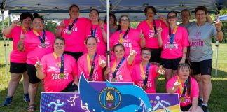 The Peterborough Special Olympic women's soccer team (Candace Bushie, Crystal Cochrane, Jasmine Davis, Haley Fowler, Heather Fowler, Nicole Hewitt, Kristen Lackey, Gillian McHugh, Miriam McHugh, Kacee Quinlan, Jenn Wildman, and Carlea Wilkie-Ellis) with coaches Debbie Quinlan, Shawna Goode, and Linda Wilkie celebrating the first-ever gold medal in the women's soccer division at the Special Olympics provincial games, held in Brantford from July 10 to 13, 2025. (Photo: Special Olympics Ontario)