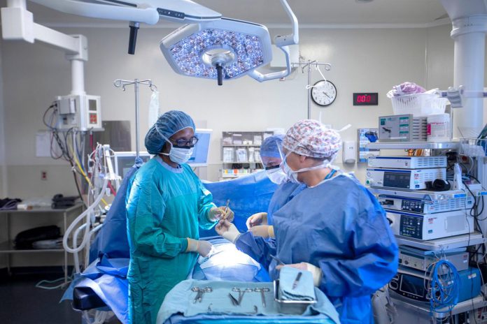 Peterborough Regional Health Centre (PRHC) vascular surgeon Dr. Heather Cox (left) and surgical nurses Kendra Kinsey (back right) and Debbie Kennedy (front right) in one of the hospital's two dedicated operating rooms for vascular surgery. Investing in a hybrid operating room through the PRHC Foundation's Campaign for PRHC will mean specialized clinical teams can perform multiple open and minimally invasive operations on the same patient on the same day and in the same room, allowing them to treat complex conditions with greater precision, less risk, and faster recovery. (Photo courtesy of PRHC Foundation)