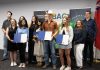 The graduates of the Summer Company program administered by the Business Advisory Centre (BAC) of Community Futures Peterborough (CFP) were celebrated at an event on August 13, 2025 at Venture North in downtown Peterborough. The graduates (holding certificates) are, left to right, Bisma Razaque, Neha Mervin, Spencer Toth, and Lauren Connolly (absent are Haydon Meade and Teaghan Hartnett). Also pictured from left to right are Joel Porter on behalf of Peterborough-Kawartha MPP Dave Smith, BAC entrepreneurship officer Allison Adam, Peterborough DBIA executive director Nour Mazloum, BAC manager Rose Terry, City of Peterborough economic development director Darryl Julott, CFP executive director Devon Girard (hidden), Peterborough County economic development manager Rhonda Keenan, and Peterborough and Kawarthas Chamber of Commerce vice-president Joel Wiebe. (Photo courtesy of Community Futures Peterborough)