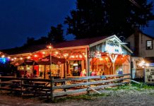 At their seasonal Keene barbeque joint Muddy's Pit BBQ, Neil and Julie Lorenzen have supported the local economy for 16 years by sourcing locally grown meats, vegetables, and beverages, and by inviting local musicians to perform during their weekly live music series. In return, several local businesses support Muddy's by selling their homemade barbeque sauce. (Photo courtesy of Muddy's Pit BBQ)