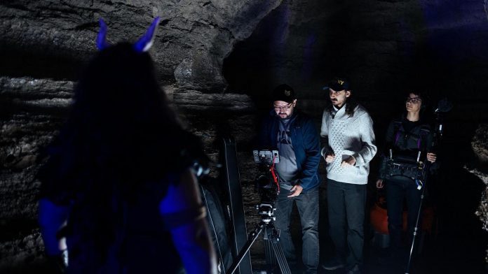 "Enkidu" co-writer and actor Jon Hedderwick (with his back to the camera), cinematographer Rob Viscardis, co-writer and director Zachary Barmania, and executive producer and sound technician Ayesha Lye during a test shoot in a deep and lightless limestone cave in Ontario. (Supplied photo)