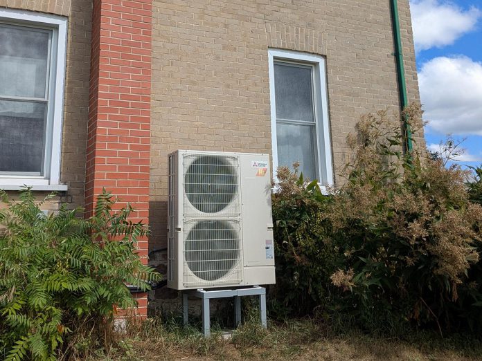 The Buxtons' heat pump, installed in 2023, provides both heating and cooling to the home. Air conditioning was an added bonus, as it was something the home never had before. The heat pump is centrally ducted and has been able to operate successfully using the home's existing ductwork. (Photo: Clara Blakelock / GreenUP)