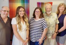 Haliburton Highlands Healthy Democracy Project (HHHDP) steering committee members Sean Pennylegion, Jessica Slade, Lauren Hunter, Barrie Martin, and Carol Moffatt in front of part of a textile collection by local artist Wendy Wood at The Link in Haliburton. To help promote greater civic engagement in the 2026 municipal election and beyond, the grassroots community group is hosting a four-part "Voices & Votes" speaker series with the first two events this fall. (Photo: HHHDP)