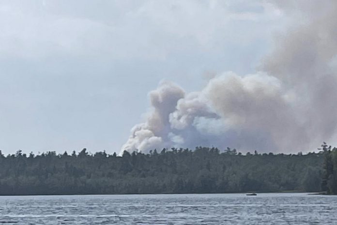 HAL019, a forest fire burning out of control in the area of County Road 49 and County Road 121 between Bobcaygeon and Kinmount in Kawartha Lakes, pictured from Bass Lake. (Photo: Laura Mclennan / Facebook) HAL019, a forest fire burning out of control in the area of County Road 49 and County Road 121 between Bobcaygeon and Kinmount in Kawartha Lakes, pictured from Bass Lake. (Photo: Laura Mclennan / Facebook)